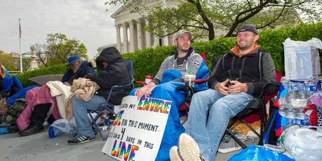 April 27, 2015: Sean Varsho, 28, of Chicago, left, and Brandon Dawson, 26, of Warrenton Va., have been waiting in line for the past three days for a seat for Tuesday's Supreme Court hearing on gay marriage. The opponents of same-sex marriage are urging the court to resist embracing what they see as a radical change in society's view of what constitutes marriage. (AP Photo/Cliff Owen)