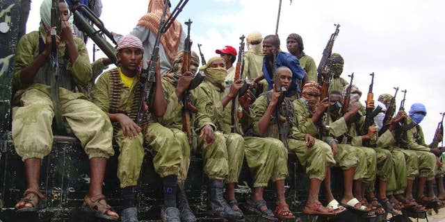 FILE - In this Oct. 30, 2009 file photo, al-Shabab fighters sit on a truck as they patrol in Mogadishu, Somalia. (AP Photo/Mohamed Sheikh Nor, File)