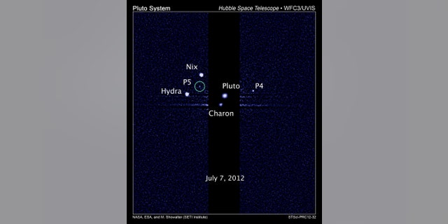 This image, taken by NASA's Hubble Space Telescope, shows five moons orbiting the distant, icy dwarf planet Pluto. The green circle marks the newly discovered moon, designated P5, as photographed by Hubble's Wide Field Camera 3 on July 7, 2012.