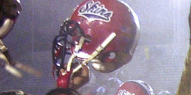 In this Dec. 8, 2001 file photo, Neshaminy teammates celebrate after their 21-7 victory over Woodland Hills to claim the Class AAAA state title in Hershey, Pa.
