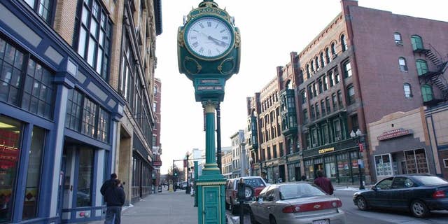 FILE - In this Feb. 26, 2007, file photo, people make their way through downtown Lowell, Mass. The Lowell Sun reported on July 11, 2016, that the city is asking the public to stop giving money to panhandlers. (AP Photo/Lisa Poole, File)