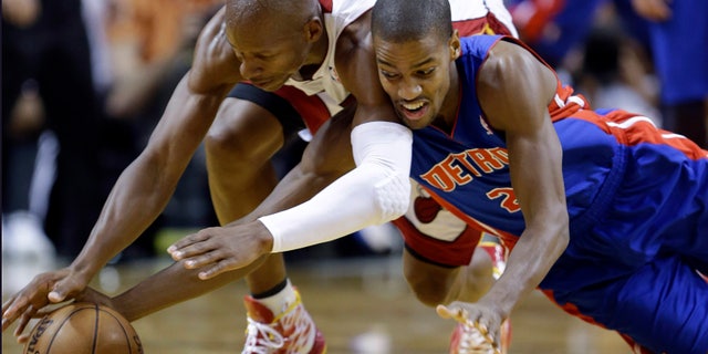 Detroit Pistons guard Kim English, right, and Miami Heat guard Ray Allen dive for a loose ball during the second half of an NBA basketball game, Friday, Jan. 25, 2013, in Miami. The Heat defeated the Pistons 110-88. (AP Photo/Wilfredo Lee)