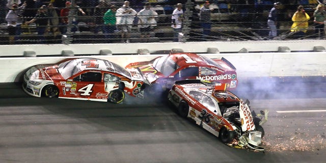 Kevin Harvick (4), Jamie McMurray (1) and Reed Sorenson (36) crash on the front stretch on the last lap of the Daytona 500 NASCAR Sprint Cup Series auto race at Daytona International Speedway in Daytona Beach, Fla., Sunday, Feb. 23, 2014. (AP Photo/John Raoux)