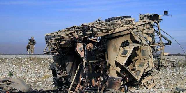 Nov. 13, 2014: A U.S. soldier inspects the site of a suicide attack targeting a foreign convey in Behsood district of Jalalabad east of Kabul