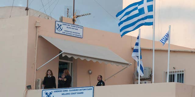 Nov. 25, 2014: Coast guards officials take a break at the Port Authority of Ierapetra on the southeast coast of the Greek island of Crete. (AP)