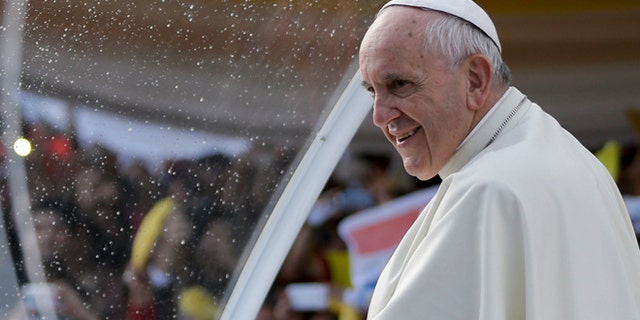 Pope Francis stands in his popemobile as he smiles at the crowds gathered in front of the women's prison, Buen Pastor in Asuncion, Paraguay, Friday, July 10, 2015. While in Paraguay, he will celebrate two Masses, including one in Caacupe, the center of Paraguayan spirituality. He'll also meet with President Horacio Cartes on Friday and with hundreds of local groups on Saturday. (AP Photo/Jorge Saenz)