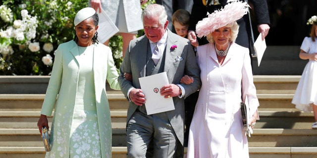 Prince Charles escorts Doria Ragland and Camilla Parker Bowles into the church.