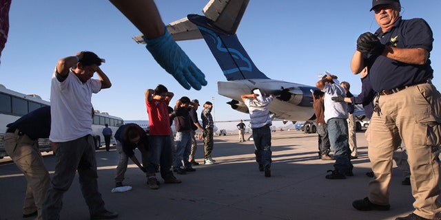 MESA, AZ - JUNE 24: Undocumented Guatemalan immigrants are body searched before boarding a deportation flight to Guatemala City, Guatemala at Phoenix-Mesa Gateway Airport on June 24, 2011 in Mesa, Arizona. The U.S. Immigration and Customs Enforcement agency, ICE, repatriates thousands of undocumented Guatemalans monthly, many of whom are caught in the controversial "Secure Communities" data-sharing program which puts local police on the frontlines of national immigration enforcement. ICE recently announced a set of adjustments to the federal program after many local communities and some states, including New York, insisted on opting out, saying immigrants were being deported for minor offenses such as traffic violations. Guatemala ranks only second to Mexico in the number of illegal immigrants deported from the United States. (Photo by John Moore/Getty Images)
