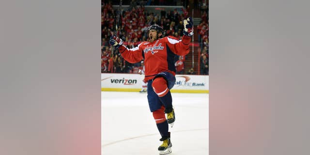 Washington Capitals left wing Alex Ovechkin (8), of Russia, celebrates his goal against the Carolina Hurricanes during the first period of an NHL hockey game, Tuesday, March 31, 2015, in Washington. It was Ovechkins' 50th goal of the year. (AP Photo/Nick Wass)