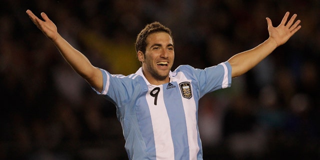 Argentina's Gonzalo Higuain celebrates after scoring his team's third goal during a World Cup 2014 qualifying soccer game against Chile in Buenos Aires, Argentina,  Friday, Oct. 7, 2011. (AP Photo/Eduardo Di Baia)