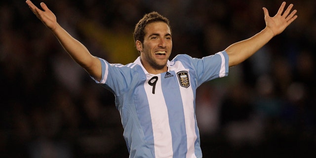 Argentina's Gonzalo Higuain celebrates after scoring his team's third goal during a World Cup 2014 qualifying soccer game against Chile in Buenos Aires, Argentina, Friday, Oct. 7, 2011. (AP Photo/Eduardo Di Baia)
