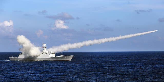 In this Friday, July 8, 2016 photo released by Xinhua News Agency, Chinese missile frigate Yuncheng launches an anti-ship missile during a military exercise in the waters near south China's Hainan Island and Paracel Islands. They are controlled by Beijing but also claimed by Vietnam and Taiwan. China's navy is holding a week of military drills around the disputed islands ahead of a ruling by an international tribunal in a case filed by the Philippines challenging China's claim to most of the South China Sea. China is boycotting the case before The Hague-based court and says it will not accept the verdict. (Zha Chunming/Xinhua via AP)