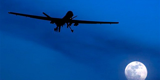 Jan. 31, 2010: This file photo shows a U.S. Predator drone flies over the moon above Kandahar Air Field, southern Afghanistan.