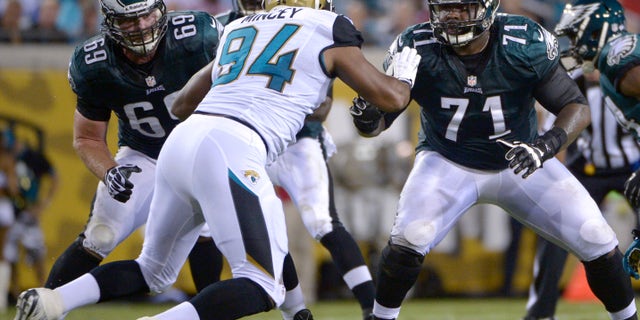 ADVANCE FOR WEEKEND EDITIONS OF DEC. 14-15 - FILE - In an Aug. 24, 2013, file photo Philadelphia Eagles guard Evan Mathis (69) and tackle Jason Peters (71) block against Jacksonville Jaguars defensive end Jeremy Mincey (94) during the first half of an NFL preseason football game in Jacksonville, Fla. Jason Peters, Evan Mathis, Jason Kelce, Todd Herremans and Lane Johnson don't get much recognition, but coaches and teammates credit the big guys upfront for helping the offense lead the NFL in rushing. (AP Photo/Phelan M. Ebenhack, File)