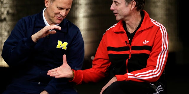 Louisville head coach Rick Pitino and Michigan head coach John Beilein, left, participate in a television interview for their NCAA Final Four tournament college basketball game Sunday, April 7, 2013, in Atlanta. Louisville plays Michigan in the championship game on Monday. (AP Photo/David J. Phillip)