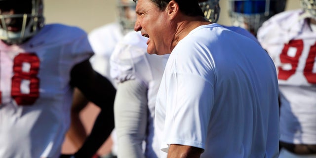 FILE - In this Oct. 2, 2013, file photo, USC Trojans' interim football coach Ed Orgeron, foreground, talks to his players during open NCAA college football practice at their Los Angeles campus. Thursday's, Oct. 10, 2013, game against Arizona will be the Trojans' first game since firing coach Lane Kiffin. (AP Photo/Damian Dovarganes, File)