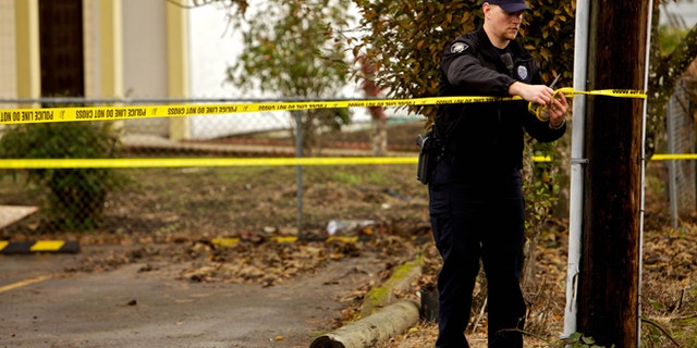 CORVALLIS, OR - NOVEMBER 28: A Corvallis police officer puts up police tape in front of the Salman Al Farisi Islamic Center on November 28, 2010 in Corvallis, Oregon. An arsonist set fire to the prayer center, which was sometimes attended by suspected Portland car bomber Mohamed Osman Mohamud. Mohamud, a Somali-born teenager, was arrested and charged with attempted use of a weapon of mass destruction when he allegedly attempted to set off a car bomb during Christmas tree lighting ceremony in Pioneer Courthouse Square in Portland, Oregon. It was reported that civilians were not at risk because the bomb was supplied to him by undercover federal agents and the explosives were inert. (Photo by Craig Mitchelldyer/Getty Images)