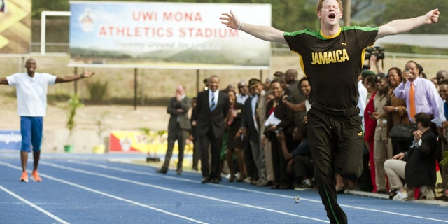 March 6: Prince Harry wins against Olympic sprint champion Usain Bolt, seen rear, by making a false start at a mock race at the University of the West Indies, in Jamaica.