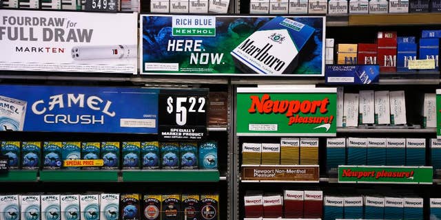 FILE - In this Friday, July 17, 2015 file photo, Camel and Newport cigarettes, both Reynolds American brands, are on display at a Smoker Friendly shop in Pittsburgh. British American Tobacco offered Friday, Oct. 21 2016 to buy Reynolds American Inc. in a $47 billion cash-and-stock deal that would create the world’s largest publicly traded tobacco company and bring together brands like Camel, Dunhill, and Newport. The logic of the deal, analysts say, is to make up for a decline in the number of smokers in their home markets of the U.S. and Britain as they look to developing markets and new products, such as electronic cigarettes. (AP Photo/Gene J. Puskar, file)