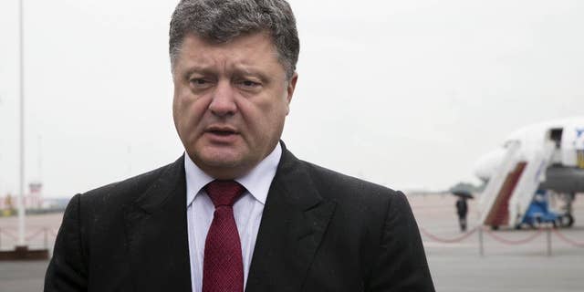 Ukrainian president Petro Poroshenko makes a statement, at Boryspil airport in Kiev, Ukraine, Thursday, Aug. 28, 2014. Poroshenko canceled his visit to Turkey on Thursday due to a "sharp escalation of the situation in the Donetsk region, particularly in Amvrosiivka and Starobeshevo, as Russian forces have entered Ukraine," he said in the statement. (AP Photo/Mikhail Palinchak)