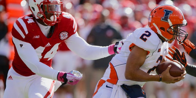 FILE - In this Oct. 5, 2013, file photo, Illinois quarterback Nathan Scheelhaase (2) is pursued and later sacked by Nebraska defensive end Randy Gregory (44) during the first half of an NCAA college football game in Lincoln, Neb. This week's game at Purdue game might not move the excitement meter for Nebraska fans. To Gregory, it's a red-letter game. He started junior college two years ago thinking he eventually would wind up at Purdue. Instead, he landed up at Nebraska. (AP Photo/Nati Harnik, File)