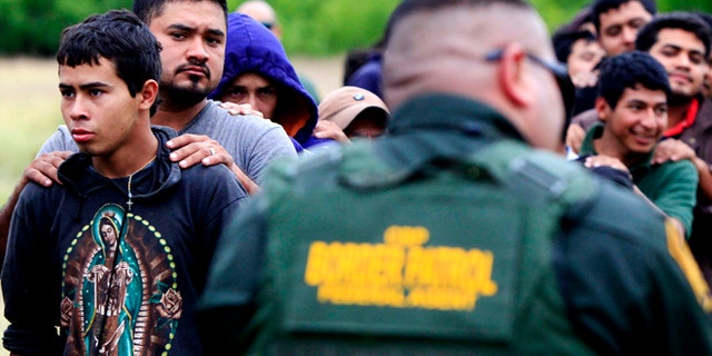 April 17, 2014: Suspected illegal immigrants being detained by U.S. Border Patrol agents, in McAllen, Texas.
