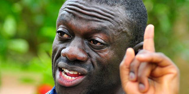 FILE - In this Wednesday, April 20, 2011 file photo, opposition leader Kiiza Besigye speaks during a rally in Kampala, Uganda. An opposition leader in Uganda who is running for president is under house arrest to prevent him from holding rallies that have been called illegal by the government, a police spokeswoman said. Kiiza Besigye of the Forum for Democratic Change party is being detained in his own home near the capital, Kampala, as a preventive measure “to ensure that there is no breach of peace,” said police spokeswoman Polly Namaye on Thursday, Oct. 15, 2015. (AP Photo/Ronald Kabuubi,File)