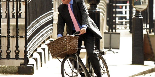 FILE - In this May 17, 2011 file photo, Andrew Mitchell arrives at Downing Street, London. Mitchell, who resigned from a government post over allegations that he used derogatory remarks against police officers called on Tuesday, Dec. 18, 2012 for a full inquiry into the dispute amid new claims that police fabricated the evidence. Mitchell quit as the government's chief whip in September after he was accused of swearing at police officers who stopped him from wheeling his bicycle through the Downing Street gates. (AP Photo/PA, Yui Mok, File) UNITED KINGDOM OUT, NO SALES, NO ARCHIVE