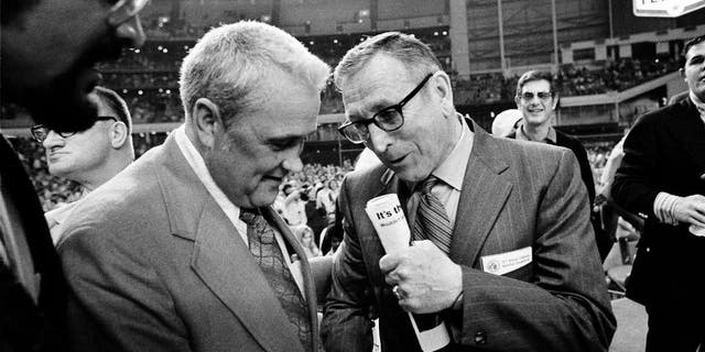 FILE - In this March 27, 1971, file photo, Villanova University basketball coach Jack Kraft, left, congratulates UCLA coach John Wooden after Wooden's Bruins defeated Villanova, 68-62, to win the NCAA championship in Houston, Texas.
