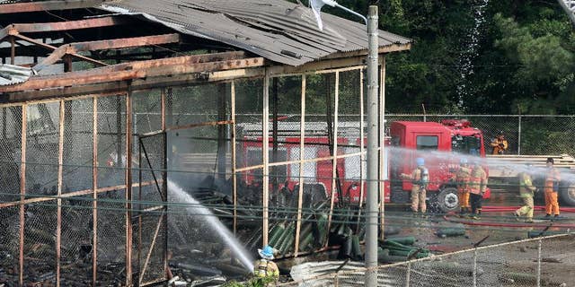 Firefighters extinguish a fire at Camp Carroll in Chilgok, South Korea, Thursday, May 19, 2016. An oxygen tank blew up at the U.S. military base in South Korea, causing a fire, but there were no reports of casualties. The U.S. military said it was investigating the cause of the blast Thursday at Camp Carroll, 280 kilometers (175 miles) southeast of the Seoul. (Kim Jun-beum/Yonhap via AP) KOREA OUT