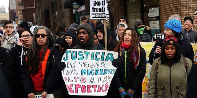 Demonstrators yell at police during a protest outside the Immigration Court in New York City on January 8, 2016 in New York City. (Photo by Spencer Platt/Getty Images)