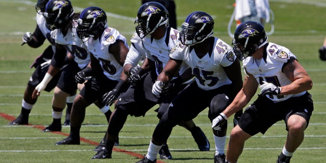 A group of Baltimore Ravens linebackers run a drill during NFL football practice at the team's training facility in Owings Mills, Md., Friday, May 31, 2013. (AP Photo/Patrick Semansky)