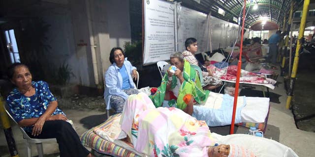 Patients spend the night outside a hospital after abandoning their rooms following a powerful earthquake that rocked Surigao city, Surigao del Norte province, in the southern Philippines, Saturday, Feb.11, 2017. Officials said, the powerful earthquake with a magnitude of 6.5, caused an undetermined number of casualties, damaged roads and buildings, including the airport, and knocked power out. (AP Photo)