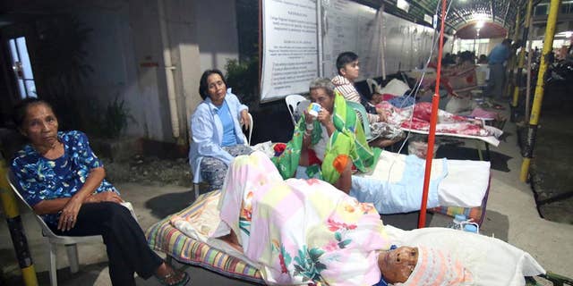 Patients spend the night outside a hospital after abandoning their rooms following a powerful earthquake that rocked Surigao city, Surigao del Norte province, in the southern Philippines, Saturday, Feb.11, 2017. Officials said, the powerful earthquake with a magnitude of 6.5, caused an undetermined number of casualties, damaged roads and buildings, including the airport, and knocked power out. (AP Photo)
