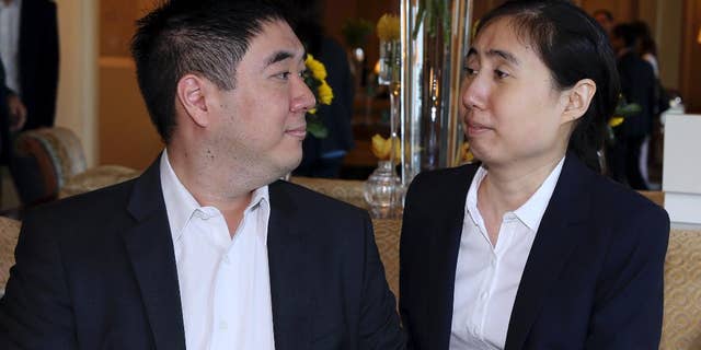 October 19, 2014: American couple Grace and Matthew Huang, sentenced to jail over charges they starved their 8-year-old adopted daughter to death, talk before they meet with U.S. Ambassador to Qatar, Dana Shell Smith, at a hotel in Doha. (AP Photo/Osama Faisal)
