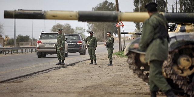 Feb. 28: Soldiers and dozens of tanks from the Libyan military's elite Khamis Brigade, led by Qaddafi youngest son Khamis Qaddafi take positions and check vehicles after arriving hours earlier on the road in Harshan, 10km east of Zawiya, in Libya.