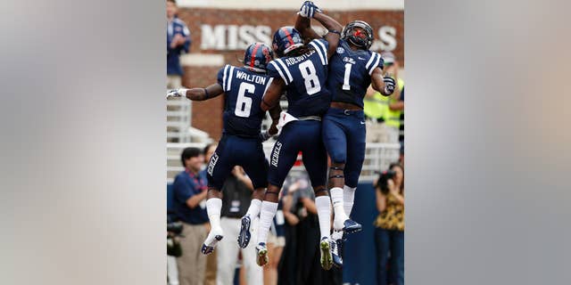 Mississippi running back Jaylen Walton (6) and teammates Quincy Adeboyejo, and Laquon Treadwell (1) celebrate Walton's 71-yard touchdown run against Louisiana-Lafayette during the second half at an NCAA college football game at Vaught-Hemingway Stadium in Oxford, Miss., Saturday, Sept. 13, 2014. No. 14 Mississippi won 56-15. (AP Photo/Rogelio V. Solis)