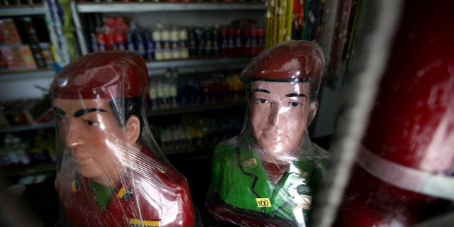 Plastic wrapped busts of Venezuela's late President Hugo Chavez sit for sale at a market in Moron, Venezuela, Thursday, April 25, 2013. Venezuelan opposition leader Henrique Capriles said Thursday the opposition would go to the Supreme Court to challenge the results of the April 14 presidential vote, which was narrowly won by Chavez's political heir, Nicolas Maduro. (AP Photo/Fernando Llano)