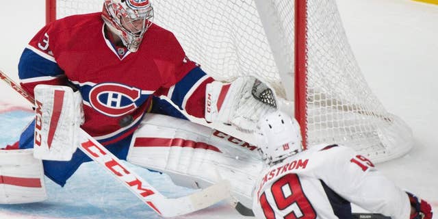 Montreal Canadiens goaltender Carey Price (31) makes a save against Washington Capitals Nicklas Backstrom during the third period of an NHL hockey preseason game Sunday, Sept. 28, 2014, in Montreal. (AP Photo/Graham Hughes)