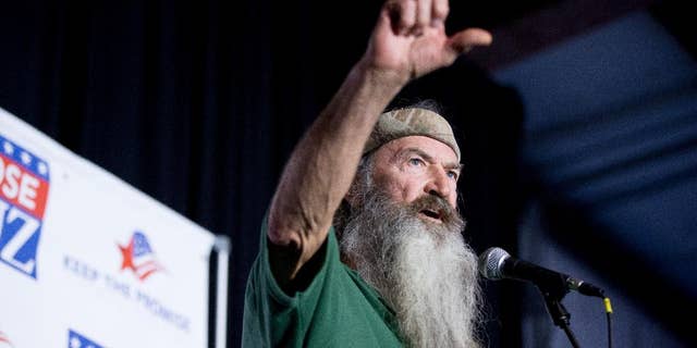 FILE - In this Feb. 19, 2016 file photo, Phil Robertson of the Duck Dynasty reality television program speaks at a rally for Republican presidential candidate, Sen. Ted Cruz, R-Texas, at Eagle Aviation Hangar in Columbia, S.C. Robertson has again clouded NASCAR's image as a sport trying to remove itself from its divisive stereotypes. Robertson called for a "Jesus man in the White House" during what was supposed to be a simple prayer before the race at Texas Motor Speedway on Saturday, April 9. (AP Photo/Andrew Harnik, File)