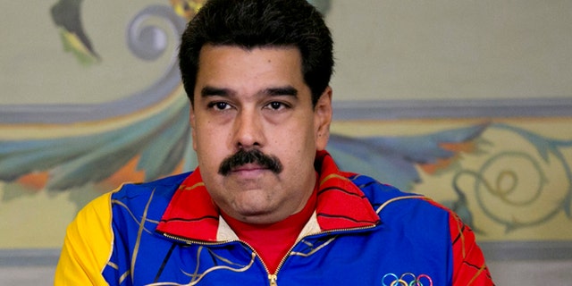 Venezuela's President Nicolas Maduro sits quietly during a ceremony for the athletes that will participate in the upcoming Toronto Pan American games, at Miraflores Presidential Palace in Caracas, Venezuela, Tuesday, June 16, 2015. President Maduro said on Monday night that a recent meeting between Venezuelan and U.S. officials has opened an important channel that could lead toward restoration of full diplomatic relations. (AP Photo/Ariana Cubillos)