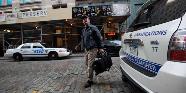Dec. 11: A medical examiner arrives at the apartment building where Mark Madoff lived in New York. Mark, one of Bernard Madoff's sons, was found dead of an apparent suicide, according to a law enforcement official.
