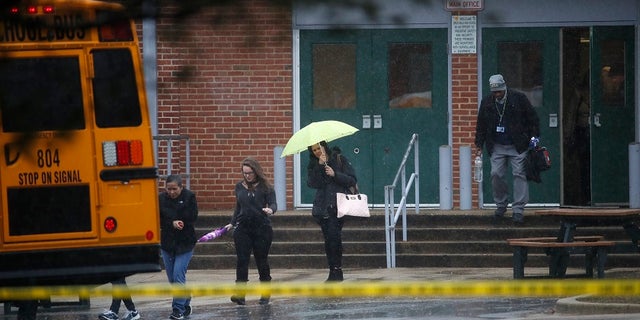 Students leave the scene of an incident at Great Mills High School on Tuesday, March 20, 2018.