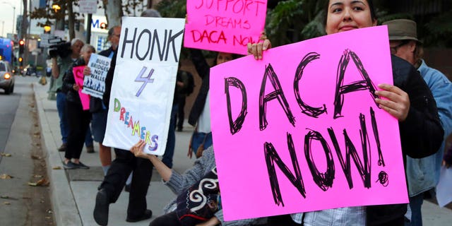 Demonstrators urging the Democratic Party to protect the Deferred Action for Childhood Arrivals Act (DACA) rally outside the office of California Democratic Sen. Dianne Feinstein in Los Angeles Wednesday, Jan. 3, 2018. California has the largest number of people who are affected by the law, also known as the Dream Act.(AP Photo/Reed Saxon)