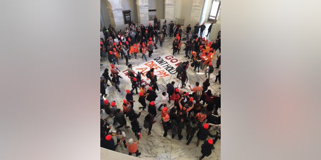 About 100 immigration protesters were seen gathering in the Russell Senate Office Building on Friday afternoon.