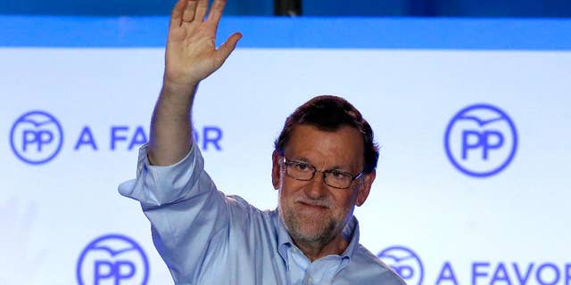 FILE - In this Sunday, June 26, 2016 file photo, Spain's then acting Primer Minister and candidate of Popular Party Mariano Rajoy, waves to his supporters as he celebrates the results of the party during the national elections in Madrid, Spain. Rajoy was re-elected as the leader of the conservative Popular Party for a fourth term on Saturday, Feb. 11, 2017. The 61-year-old Rajoy ran unopposed and won with 95% of the vote at the party congress in Madrid. (AP Photo/Daniel Ochoa de Olza, File)