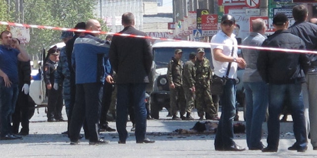 May 1, 2013: Police and forensic experts examine the site of an explosion in downtown Makhachkala, Dagestan. Russian police say a bomb exploded in a busy shopping area in the capital of the restive republic of Dagestan, killing at least two people. Dagestan is plagued by Islamic insurgents who frequently mount small attacks on police.