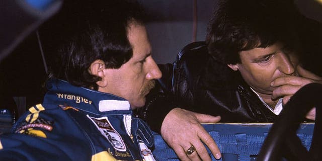 Driver Dale Earnhardt (L) and car owner Richard Childress are deep in conversation at a NASCAR Cup race, circa 1985. Earnhardt brought the Wrangler sponsorship to Childress racing in 1984 and began a relationship that lasted until 2001, earning the team six Cup championships. (Photo by ISC Images & Archives via Getty Images)