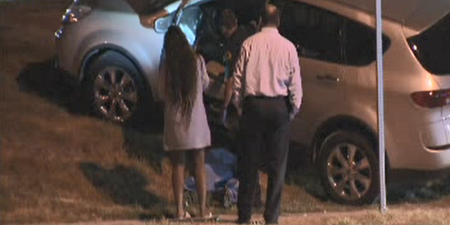 A mother shot a man in the face after the suspect jumped into her car while her two kids were sitting in the vehicle, police said.