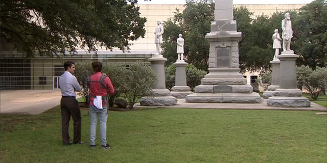 Police have set up barricades around this confederate statue in Pioneer Park Cemetery in preparation for Saturday's rally against hate in front of Dallas City Hall.